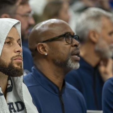 Jan 15, 2025; Minneapolis, Minnesota, USA; Golden State Warriors guard Stephen Curry (30) looks on from the bench against the Minnesota Timberwolves in the second half at Target Center. Mandatory Credit: Jesse Johnson-Imagn Images