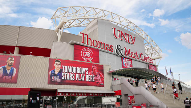 Fans walk outside the Thomas & Mack Center before the start of an NBA Summer League game