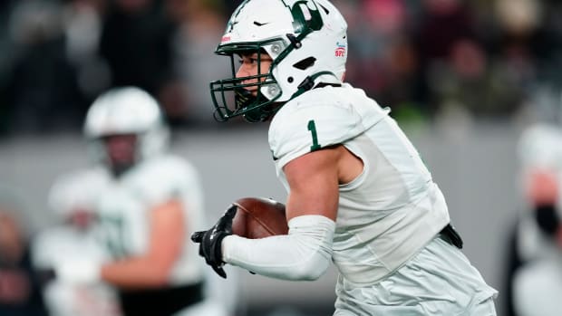 Philip Folmar, of Delbarton, runs with the ball after completing a pass,