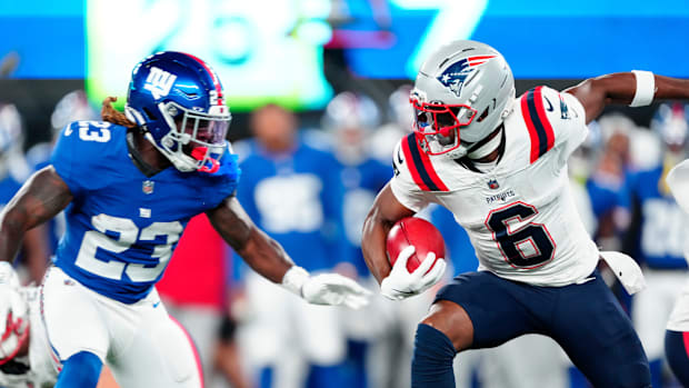 New England Patriots wide receiver Javon Baker (right, 6) looks for a way past New York Giants safety Anthony Johnson Jr.