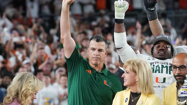 Miami Hurricanes head coach Mario Cristobal holds the Vrbo Fiesta Bowl trophy after their 31-27 win over the Ole Miss Rebels at State Farm Stadium on Jan. 8, 2026.