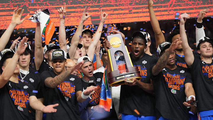 Apr 7, 2025; San Antonio, TX, USA;  Florida Gators players celebrate with the trophy after defeating the Houston Cougars in the national championship game of the Final Four of the 2025 NCAA Tournament at the Alamodome. Mandatory Credit: Robert Deutsch-Imagn Images