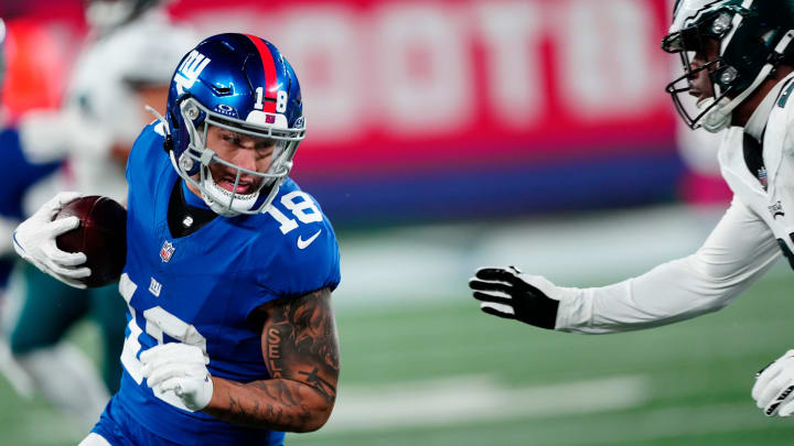 New York Giants wide receiver Isaiah Hodgins (18) tries to avoid Philadelphia Eagles cornerback Kelee Ringo (22), Sunday, January 7, 2024.