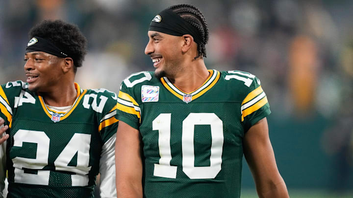 Green Bay Packers quarterback Jordan Love (10) reacts with cornerback Carrington Valentine (24) after the game against the Cincinnati Bengals at Lambeau Field.