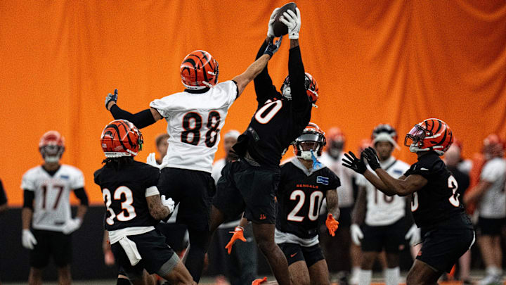 Cincinnati Bengals linebacker Shaka Heyward (50) intercepts a pass intended for Cincinnati Bengals tight end Mike Gesicki (88) at Bengals spring practice at the IEL Indoor Facility in Cincinnati on Wednesday, June 12, 2024.