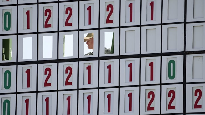 A course worker changes the leaderboard on the 18th hole during the first round of the 2025 Masters tournament. A course worker changes the leaderboard on the 18th hole during the first round of the 2025 Masters tournament.