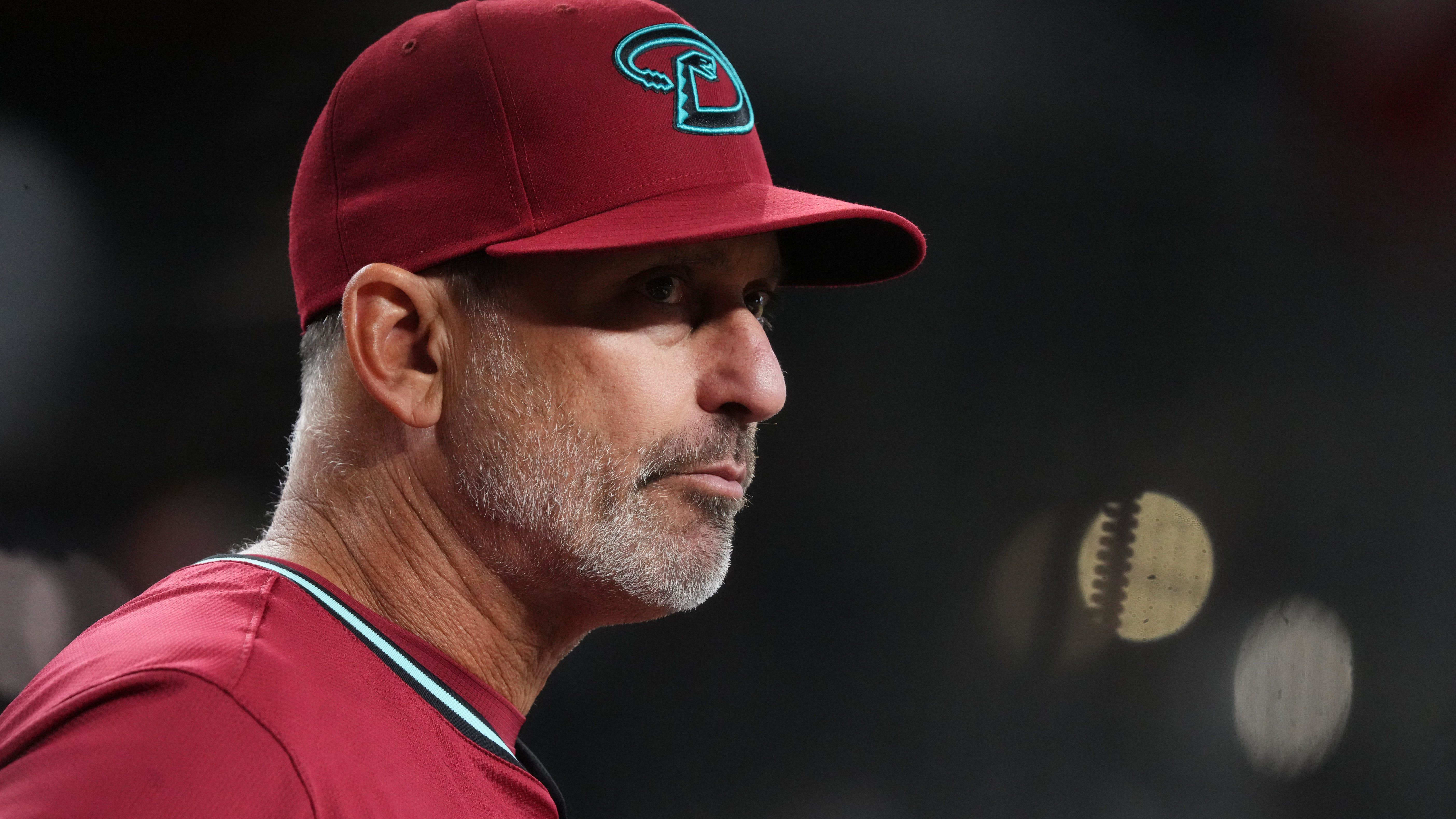 Arizona Diamondbacks head coach Torey Lovullo (17) watches from the dugout as his team takes on the Rockies