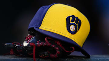 Jul 3, 2024; Denver, Colorado, USA; Detailed view of a Milwaukee Brewers cap and glove during the game against the Colorado Rockies at Coors Field. Mandatory Credit: Ron Chenoy-Imagn Images
