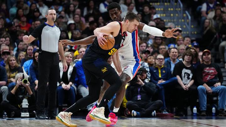 Jan 7, 2024; Denver, Colorado, USA; Denver Nuggets center Nikola Jokic (15) drives at Detroit Pistons center Jalen Duren (0): Ron Chenoy-Imagn Images