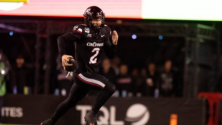 Cincinnati Bearcats quarterback Brendan Sorsby (2) runs for a first down in the fourth quarter of the NCAA football game between the Cincinnati Bearcats and BYU Cougars at Nippert Stadium in Cincinnati on Nov. 22, 2025.