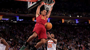 Oct 22, 2025; New York, New York, USA; Cleveland Cavaliers guard Jaylon Tyson (20) hangs on the rim after a dunk against New York Knicks guard Mikal Bridges (25) during the second quarter at Madison Square Garden. Mandatory Credit: Brad Penner-Imagn Images