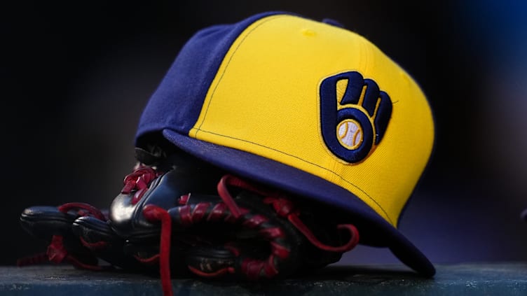 Jul 3, 2024; Denver, Colorado, USA; Detailed view of a Milwaukee Brewers cap and glove during the game against the Colorado Rockies at Coors Field. Mandatory Credit: Ron Chenoy-USA TODAY Sports