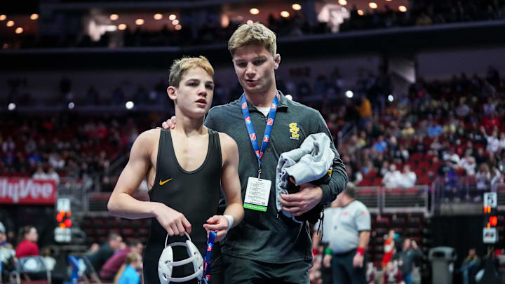 Southeast Polk's Nico DeSalvo walks off the mat with his coach during the 3A-106 first round Wednesday, Feb. 14, 2024, at Wells Fargo Arena.