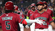 Arizona Diamondbacks' Adrian Del Castillo (25) celebrates his 3-run home run with teammate Alek Thomas (5) as they play the Colorado Rockies at Chase Field on Aug. 10, 2025.