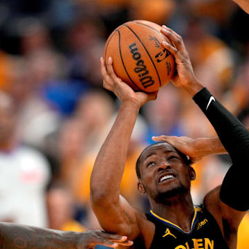 May 12, 2025; San Francisco, California, USA; Golden State Warriors forward Jonathan Kuminga (00) is fouled while attempting a shot between Minnesota Timberwolves forward Julius Randle (30) and center Rudy Gobert (27) in the fourth quarter during game four of the second round for the 2025 NBA Playoffs at Chase Center. Mandatory Credit: Cary Edmondson-Imagn Images
