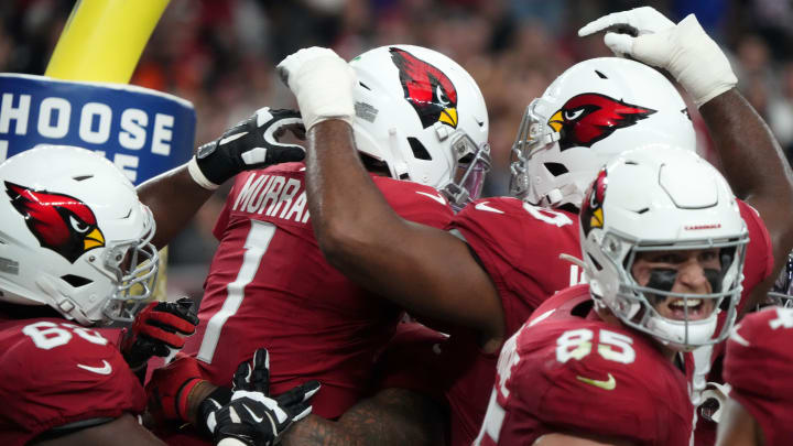 Arizona Cardinals teammates congratulate quarterback Kyler Murray (1) on his touchdown run against the Atlanta Falcons at State Farm Stadium.