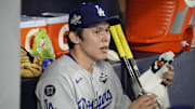 Oct 31, 2025; Toronto, Ontario, CAN; Los Angeles Dodgers pitcher Roki Sasaki (11) looks on in the dugout against the Toronto Blue Jays in the eighth inning during game six of the 2025 MLB World Series at Rogers Centre. Mandatory Credit: John E. Sokolowski-Imagn Images