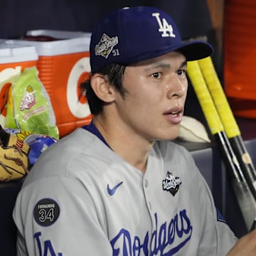 Oct 31, 2025; Toronto, Ontario, CAN; Los Angeles Dodgers pitcher Roki Sasaki (11) looks on in the dugout against the Toronto Blue Jays in the eighth inning during game six of the 2025 MLB World Series at Rogers Centre. Mandatory Credit: John E. Sokolowski-Imagn Images