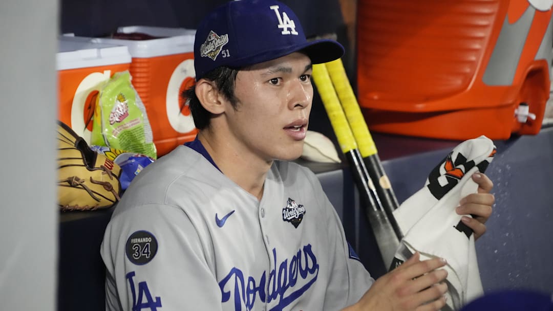 Oct 31, 2025; Toronto, Ontario, CAN; Los Angeles Dodgers pitcher Roki Sasaki (11) looks on in the dugout against the Toronto Blue Jays in the eighth inning during game six of the 2025 MLB World Series at Rogers Centre. Mandatory Credit: John E. Sokolowski-Imagn Images