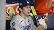 Oct 31, 2025; Toronto, Ontario, CAN; Los Angeles Dodgers pitcher Roki Sasaki (11) looks on in the dugout against the Toronto Blue Jays in the eighth inning during game six of the 2025 MLB World Series at Rogers Centre. Mandatory Credit: John E. Sokolowski-Imagn Images