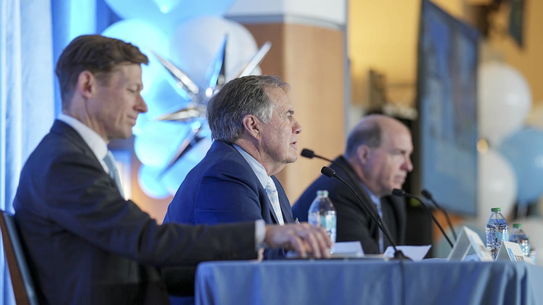 North Carolina Tar Heels chancellor Lee Roberts, new head coach Bill Belichick and athletic director Bubba Cunningham North Carolina Tar Heels chancellor Lee Roberts, new head coach Bill Belichick and athletic director Bubba Cunningham