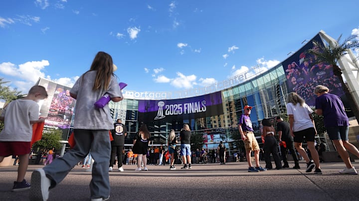 Fans walk into the Mortgage Matchup Center for WNBA Finals Game 3 between the Phoenix Mercury and Las Vegas Aces in Phoenix on Oct. 8, 2025.