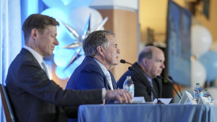 North Carolina Tar Heels chancellor Lee Roberts, new head coach Bill Belichick and athletic director Bubba Cunningham North Carolina Tar Heels chancellor Lee Roberts, new head coach Bill Belichick and athletic director Bubba Cunningham