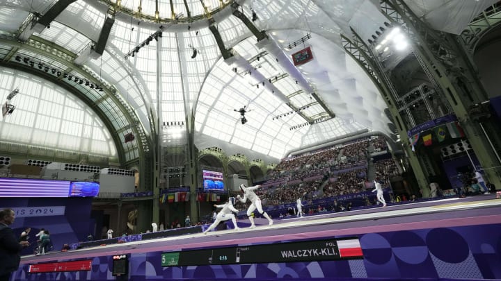 Jul 28, 2024; Paris, France; Julia Walczyk-Klimaszyk (POL) competes against Ysaora Thibus (FRA) in a women's foil individual table of 32 match during the Paris 2024 Olympic Summer Games at Grand Palais. Mandatory Credit: Andrew P. Scott-USA TODAY Sports