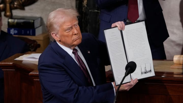 President Donald Trump holds up an executive order that renames a wildlife sanctuary in honor of the late Jocelyn Nungaray, a 12 year-old girl who was allegedly murdered by two undocumented migrants, during an address to a joint session of Congress at the U.S. Capitol in Washington, D.C., on March 4, 2025.