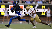 Nov 16, 2024; Dallas, Texas, USA; SMU Mustangs running back Brashard Smith (1) and Boston College Eagles defensive back Ashton McShane (35) in action during the game between the SMU Mustangs and the Boston College Eagles at Gerald J. Ford Stadium. Mandatory Credit: Jerome Miron-Imagn Images