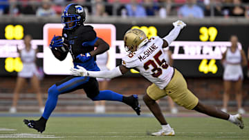 Nov 16, 2024; Dallas, Texas, USA; SMU Mustangs running back Brashard Smith (1) and Boston College Eagles defensive back Ashton McShane (35) in action during the game between the SMU Mustangs and the Boston College Eagles at Gerald J. Ford Stadium. Mandatory Credit: Jerome Miron-Imagn Images