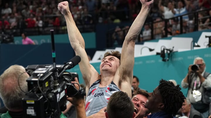 Stephen Nedoroscik reacts with teammates after he performs on the pommel horse during the men’s team final during the 2024 Paris Olympics.