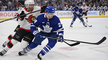 Apr 20, 2025; Toronto, Ontario, CAN; Toronto Maple Leafs forward Scott Laughton (24)and Ottawa Senators defenseman Nick Jensen (3) battle for position during the first period of game one of the first round of the 2025 Stanley Cup Playoffs at Scotiabank Arena. Mandatory Credit: John E. Sokolowski-Imagn Images