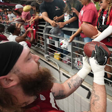 Arizona Cardinals offensive lineman Jonah Williams (73) signs autographs for fans during training camp at State Farm Stadium in Glendale on July 25, 2024.