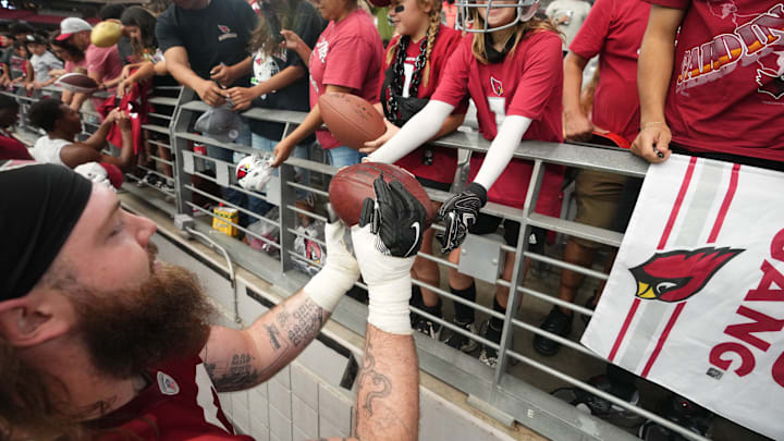 Arizona Cardinals offensive lineman Jonah Williams (73) signs autographs for fans during training camp at State Farm Stadium in Glendale on July 25, 2024.