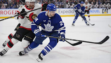 Apr 20, 2025; Toronto, Ontario, CAN; Toronto Maple Leafs forward Scott Laughton (24)and Ottawa Senators defenseman Nick Jensen (3) battle for position during the first period of game one of the first round of the 2025 Stanley Cup Playoffs at Scotiabank Arena. Mandatory Credit: John E. Sokolowski-Imagn Images