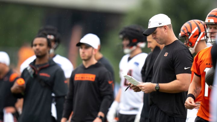 Cincinnati Bengals head coach Zac Taylor looks over plays at Cincinnati Bengals training camp on the Kettering Health Practice Fields in Cincinnati on Sunday, July 28, 2024.