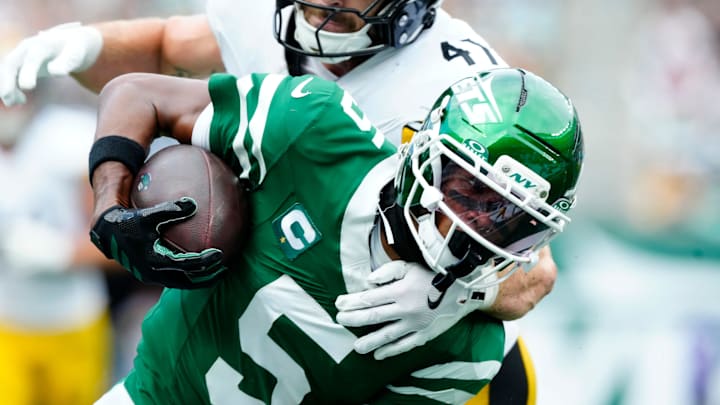 New York Jets wide receiver Garrett Wilson holds onto the ball as he is tackled by Pittsburgh Steelers linebacker Payton Wilson. New York Jets wide receiver Garrett Wilson holds onto the ball as he is tackled by Pittsburgh Steelers linebacker Payton Wilson.