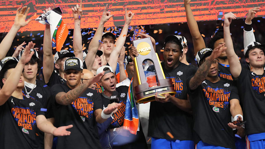 Florida Gators players celebrate with the NCAA Tournament trophy. | Robert Deutsch-Imagn Images