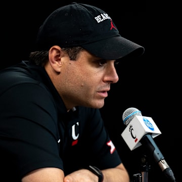 Cincinnati Bearcats head coach Wes Miller speaks at a podium at First Third Arena in Cincinnati on Wednesday, July 16, 2025.
