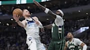 Apr 8, 2025; Milwaukee, Wisconsin, USA; Milwaukee Bucks guard Damian Lillard (0) drives to the basket against Milwaukee Bucks forward Bobby Portis (9) in the first half at Fiserv Forum. Mandatory Credit: Michael McLoone-Imagn Images