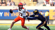 Oct 26, 2024; Berkeley, California, USA; Oregon State Beavers quarterback Ben Gulbranson (17) scrambles against California Golden Bears linebacker David Reese (right) during the fourth quarter at California Memorial Stadium. Mandatory Credit: Darren Yamashita-Imagn Images
