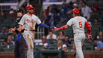 Jun 27, 2025; Atlanta, Georgia, USA; Philadelphia Phillies shortstop Trea Turner (7) celebrates with second baseman Bryson Stott (5) after scoring a run against the Atlanta Braves in the first inning at Truist Park. Mandatory Credit: Brett Davis-Imagn Images
