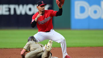 Jul 20, 2024; Cleveland, Ohio, USA; San Diego Padres center fielder Jackson Merrill (3) dives back to second as Cleveland Guardians second baseman Andres Gimenez (0) waits for the pickoff throw during the fourth inning at Progressive Field. Mandatory Credit: Ken Blaze-USA TODAY Sports
