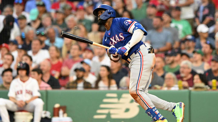 Aug 14, 2024; Boston, Massachusetts, USA; Texas Rangers designated hitter Adolis Garcia (53) hits a solo home run against the Boston Red Sox during the sixth inning at Fenway Park. Mandatory Credit: Brian Fluharty-USA TODAY Sports