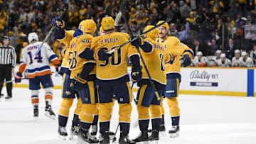 Apr 8, 2025; Nashville, Tennessee, USA;  Nashville Predators left wing Michael Bunting (58) celebrates his goal with his teammates  on the tying deflection from the shot of center Steven Stamkos (91) against the New York Islanders during the third period at Bridgestone Arena. Mandatory Credit: Steve Roberts-Imagn Images