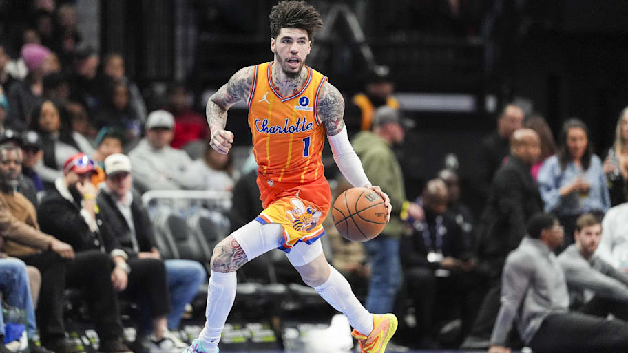 Hornets guard LaMelo Ball brings the ball up court against the Wizards.