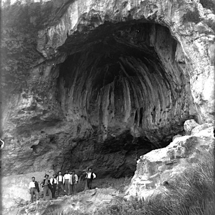 Archaeologists stand outside the Cova Negra cave in Valencia, Spain, in 1928.