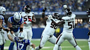 Nov 30, 2025; Indianapolis, Indiana, USA; Houston Texans defensive tackle Sheldon Rankins (90) and Houston Texans defensive end Will Anderson Jr. (51) celebrate after sacking Indianapolis Colts quarterback Daniel Jones (17) during the first half at Lucas Oil Stadium. Mandatory Credit: Robert Goddin-Imagn Images
