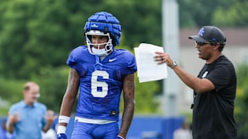 Kentucky offensive coordinator Bush Hamdan talks with wide receiver Dane Key during practice Friday. August 2, 2024 in Lexington.